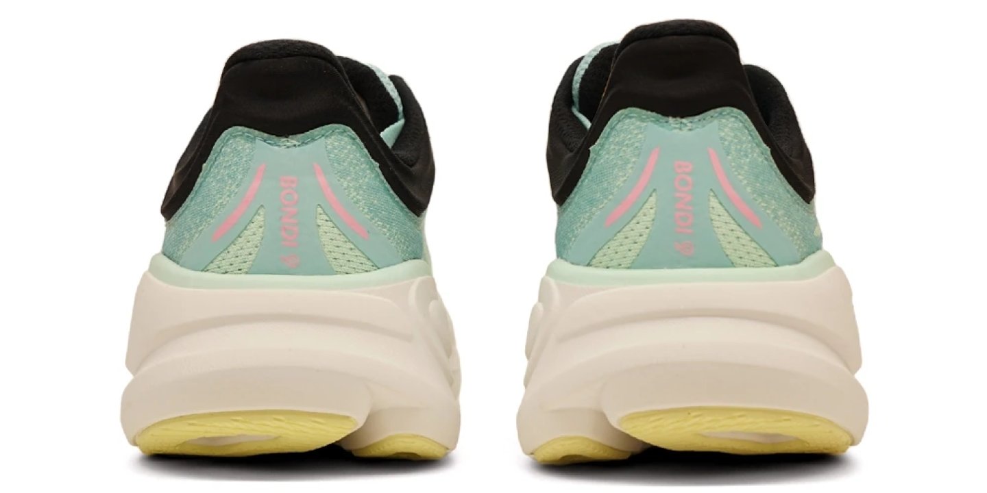 Rear view of the Hoka Bondi 9 running shoe in mint green and black with a cream oversized midsole and yellow outsole