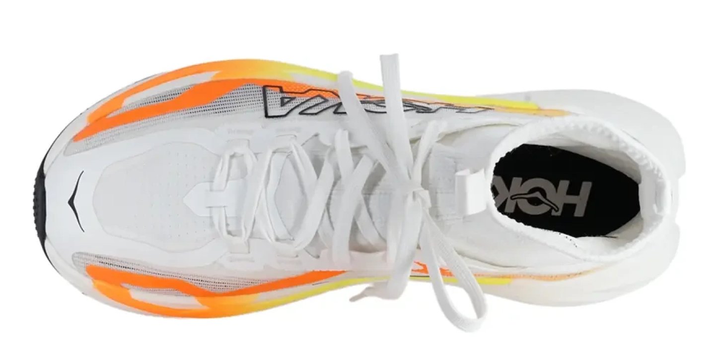 Hoka Tecton X 4 trail running shoe top view, white mesh upper with orange and yellow highlights, white laces