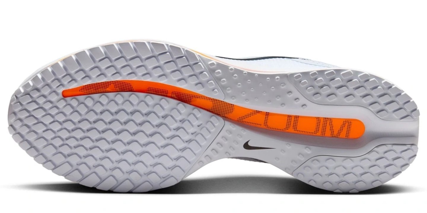 Bottom view of the Nike Pegasus Premium Zoom running shoe outsole showing waffle rubber tread and orange Zoom Air pod