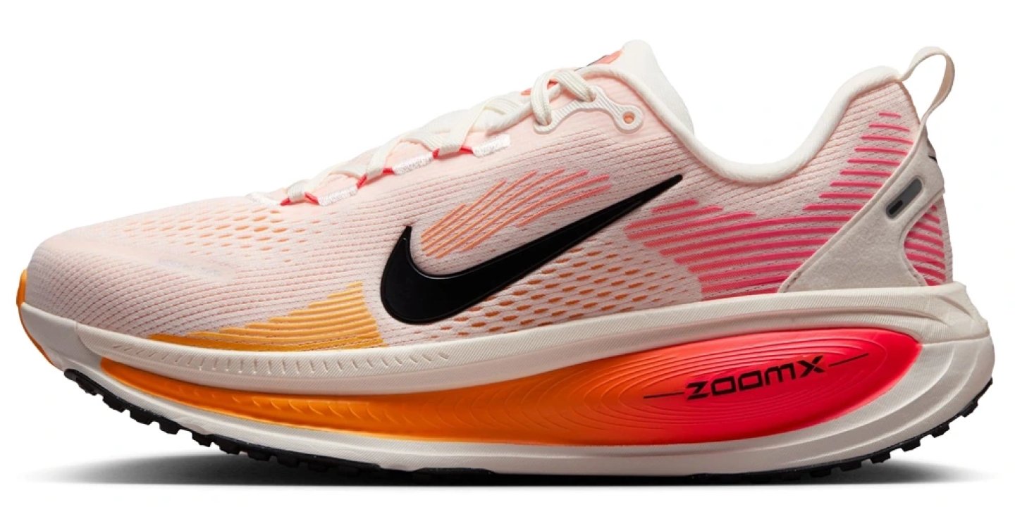 Nike Vomero 18 running shoe lateral view, light pink upper with orange and red ZoomX midsole and black Swoosh logo