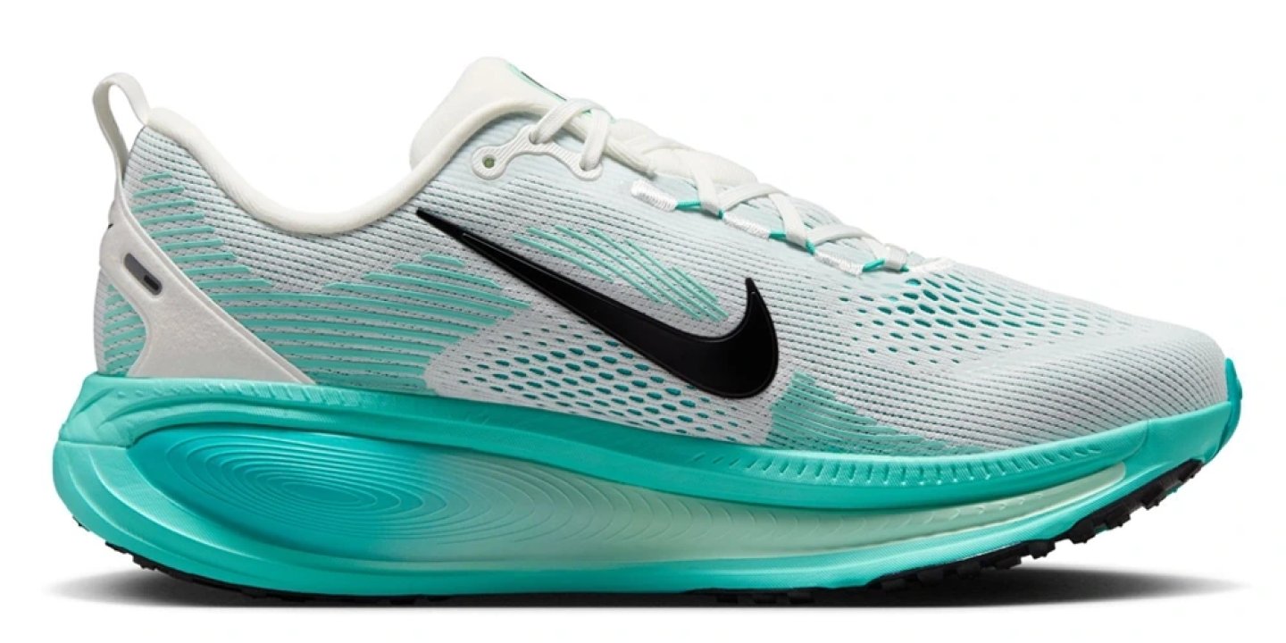 Nike Vomero 18 running shoe in white and teal, lateral side view showing mesh upper and thick foam midsole.