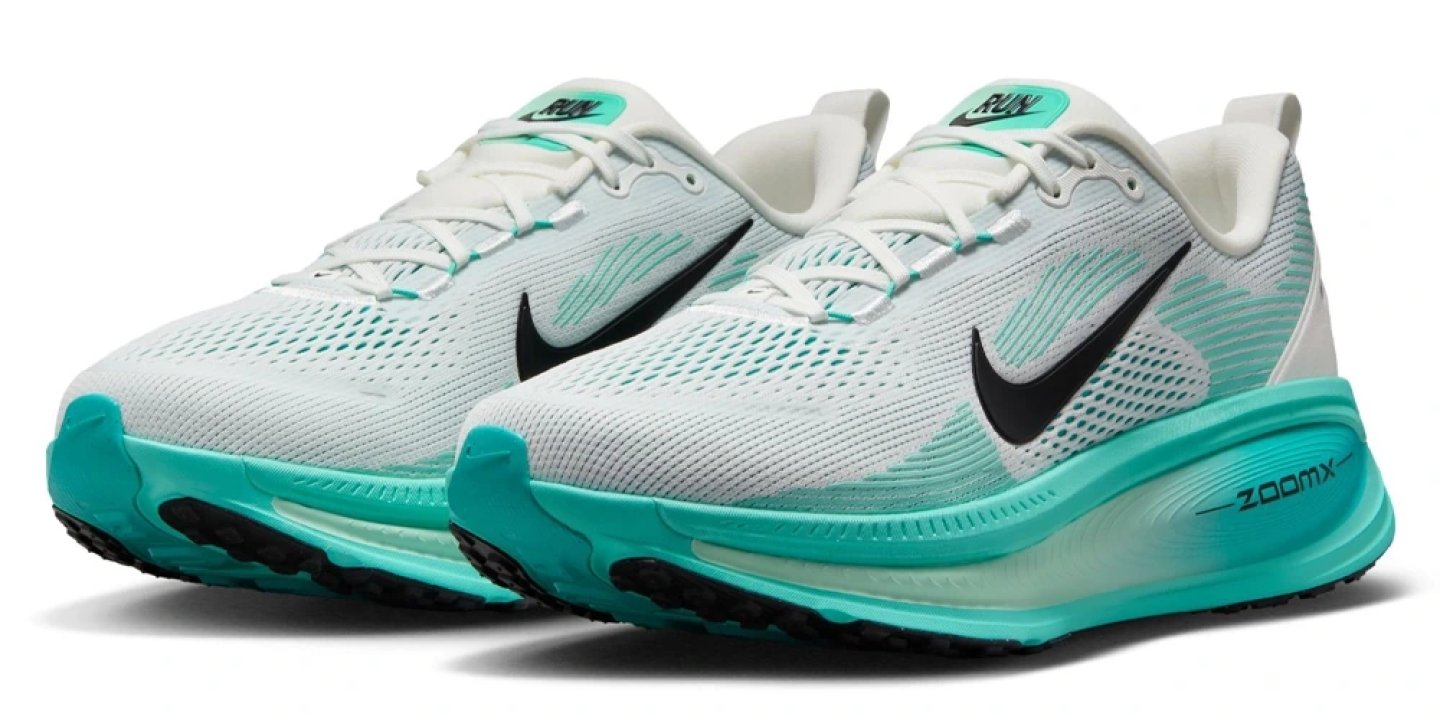Nike Vomero 18 running shoes in white and teal with black Swoosh and ZoomX midsole, pair angled view