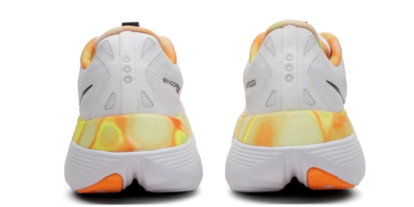 Rear view of the Saucony Endorphin Trainer running shoes with tie-dye orange and yellow midsole and white outsole