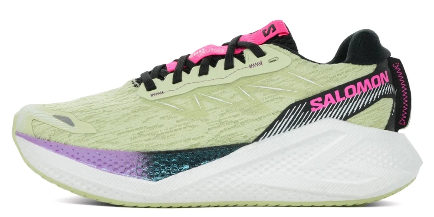 Salomon Aero Glide running shoe in lime green with pink branding, black laces, and a thick white cushioned midsole