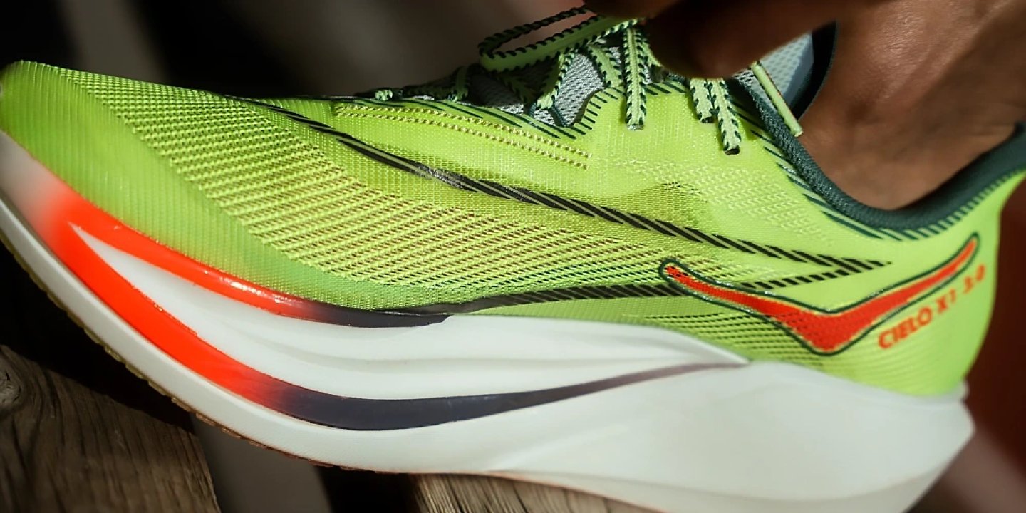 Saucony Cielo X1 3.0 running shoe in neon green with orange accents and white carbon-plated midsole, side profile view