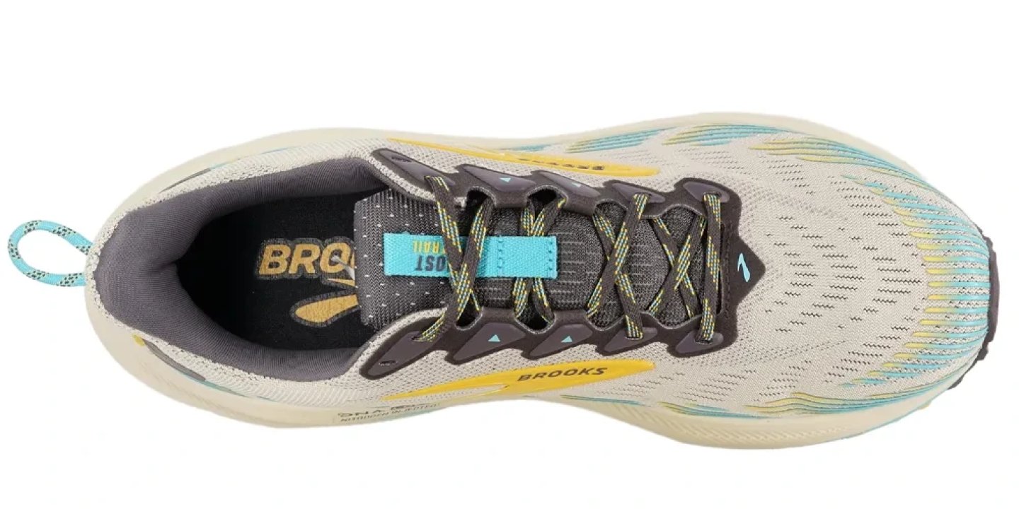 Brooks Ghost Max Trail running shoe aerial top view showing beige mesh upper with teal, gold and dark grey overlays
