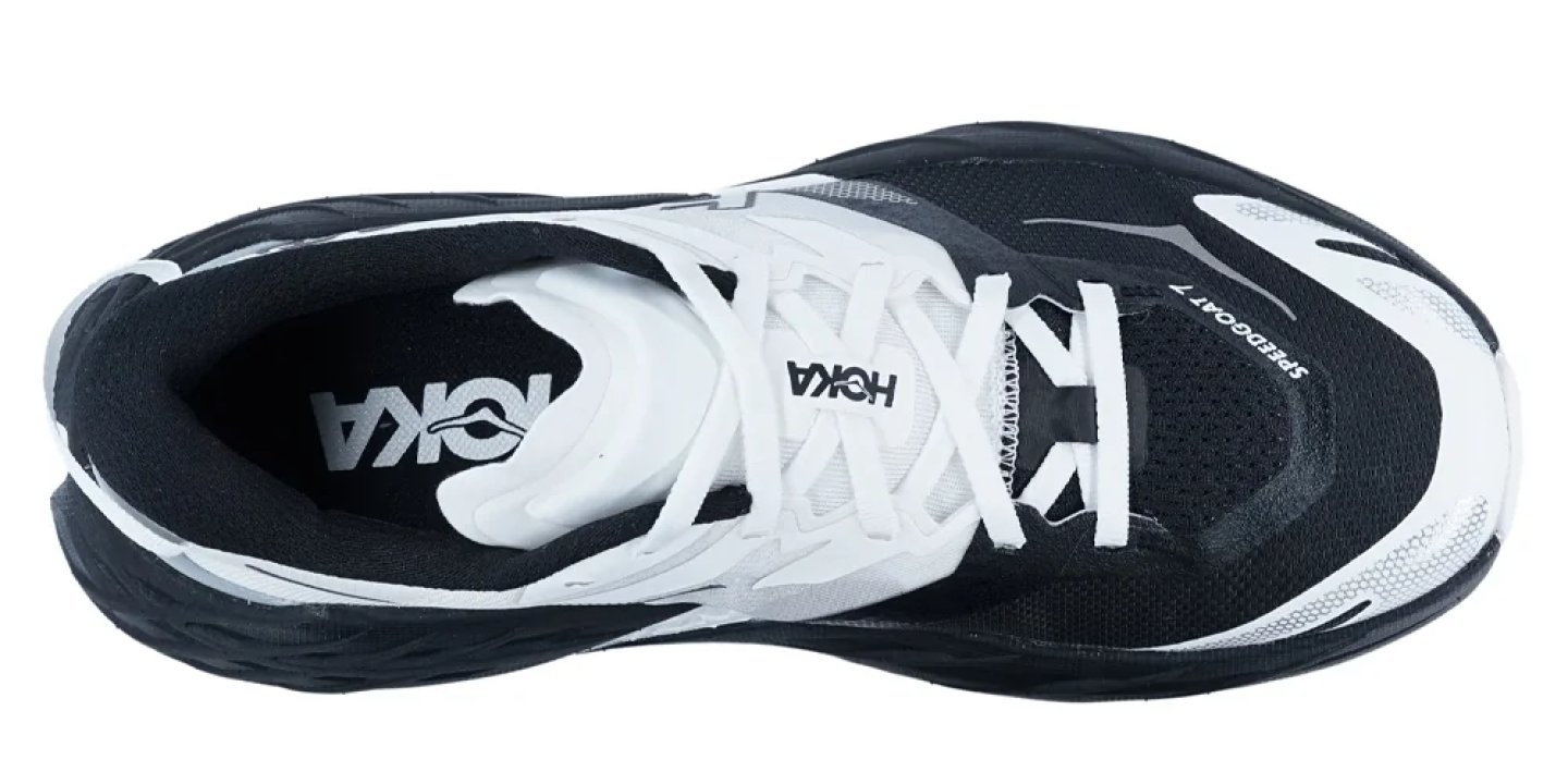 Hoka Speedgoat 7 trail running shoe in black and white, viewed from above showing mesh upper and white laces.