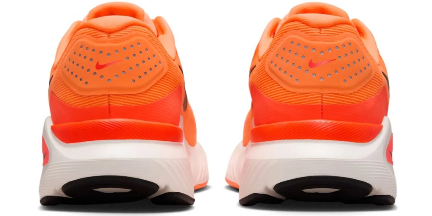 Rear view of a pair of Nike running shoes in bright orange with white midsole, perforated heel collar, and red Swoosh logo.