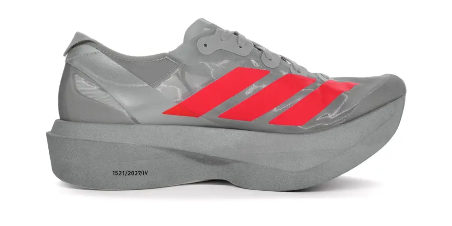 Adidas Adizero racing shoe in silver-grey with red Three Stripes, thick foam midsole, lateral side view.