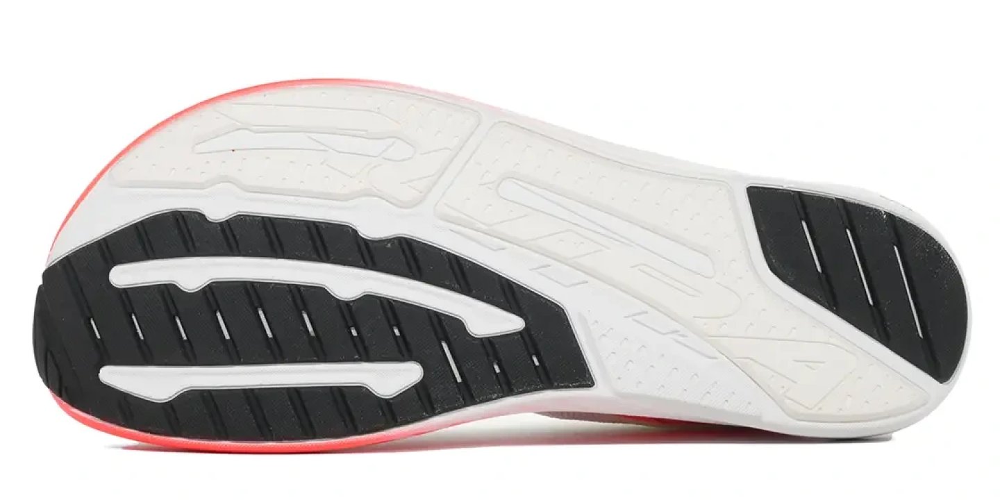 Bottom view of the Altra Vanish Pulse running shoe outsole showing white and black rubber traction zones and coral midsole edge.