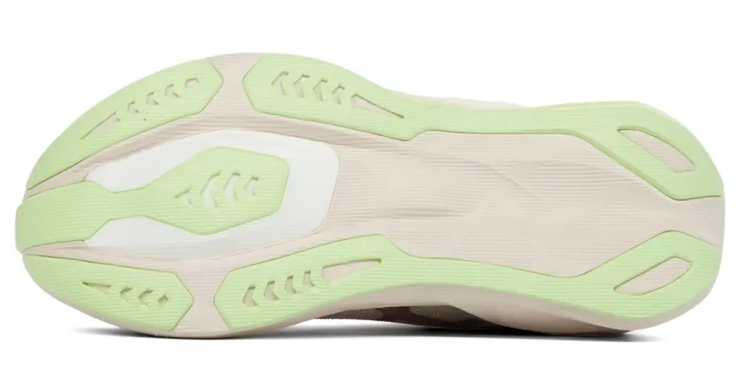 Bottom view of the ASICS Novablast 6 running shoe outsole featuring light green rubber traction pods on a cream base
