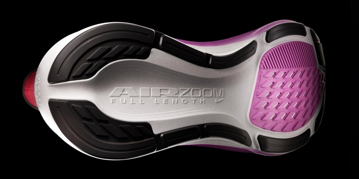 Bottom view of Nike Air Zoom Full Length running shoe outsole showing purple forefoot rubber.