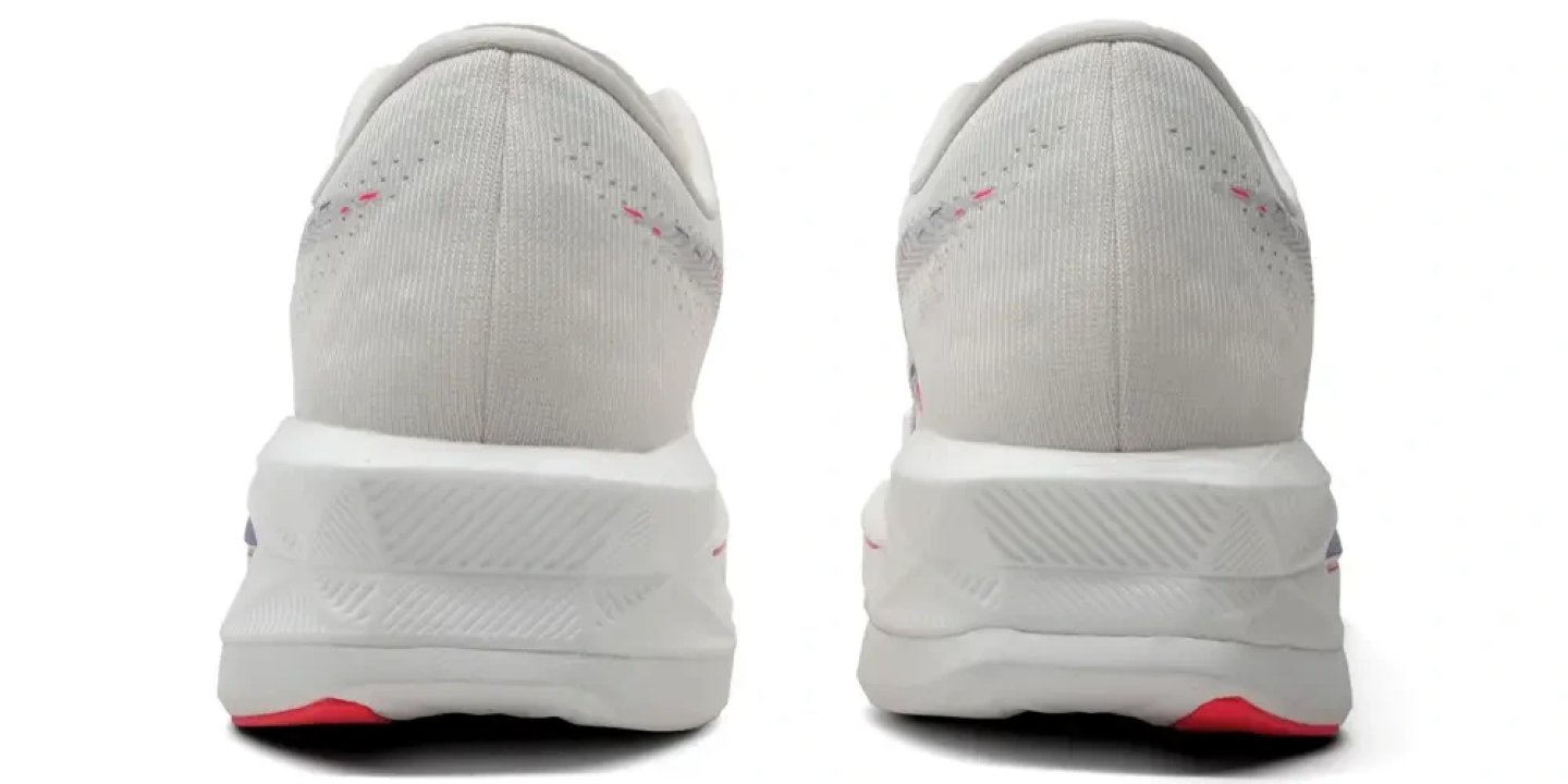 Rear view of a pair of Asics running shoes in white with pink stitching accents and red outsole detail
