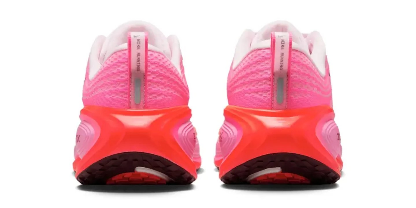Rear view of Nike Running shoes in hot pink mesh upper with bright orange chunky cushioned midsole.