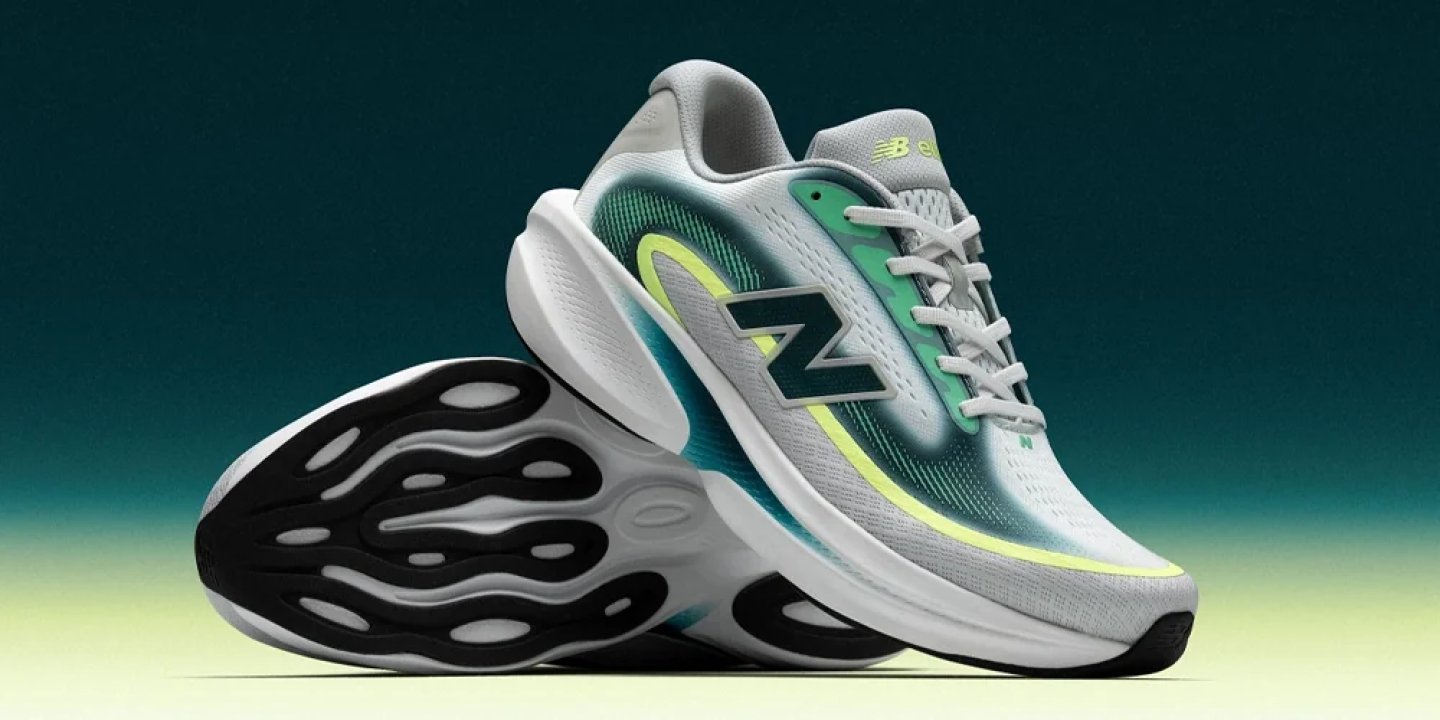 New Balance running shoes in grey, teal and lime yellow with chunky white midsole and patterned black outsole.