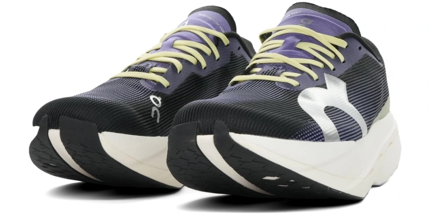 Pair of On Cloudboom Volt running shoes in black, purple and white with carbon plate midsole and yellow-green laces