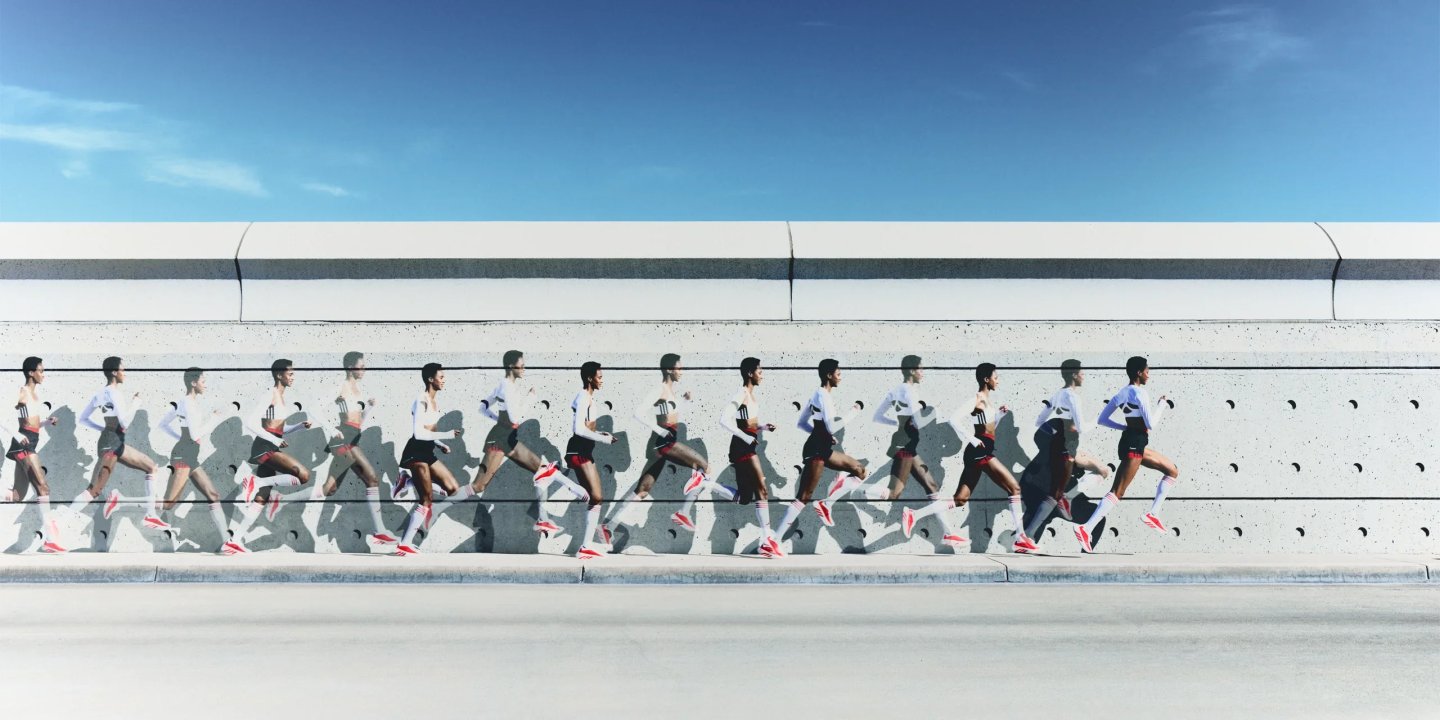 Male runner in Adidas white top and red running shoes shown in stroboscopic motion sequence against a concrete wall.